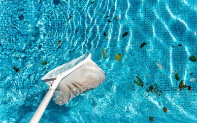 maintenance man using a pool net leaf skimmer rake 2022 05 04 22 36 55 utc Pool Skimmer Basket Care: Emptying, Cracks, and Pump Protection