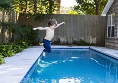 Young Boy Happily Jumping to the Pool